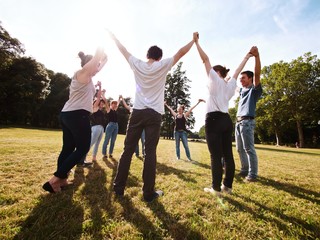large group of friends tohether in a park having fun