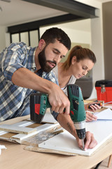 Fototapeta premium Couple assembling new furniture