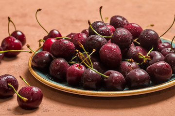 Cherries in a bowl with water drops 