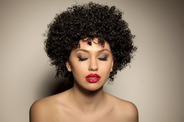 beautiful young woman with black curly wig