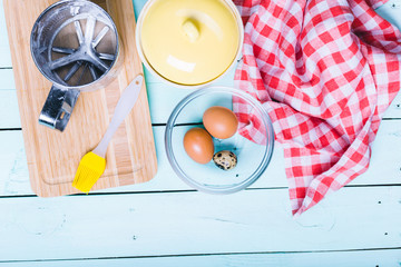 Preparation of the dough. Ingredients for the dough - Eggs and flour with a rolling pin. On wooden background.