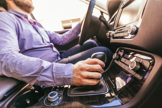 Close-up of a male hand  in a modern car