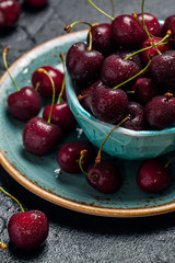 Cherries in a bowl with water drops 
