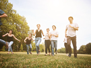 large group of friends together in a park having fun