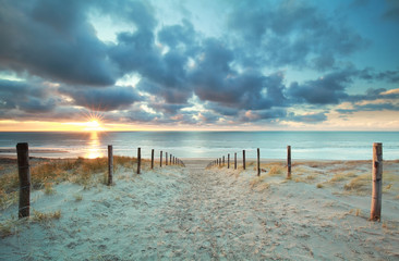 Fototapeta na wymiar sunshine on sand path to sea beach