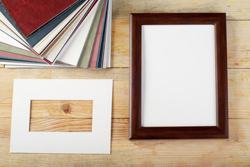 Blank frame on wooden background with sawdust.