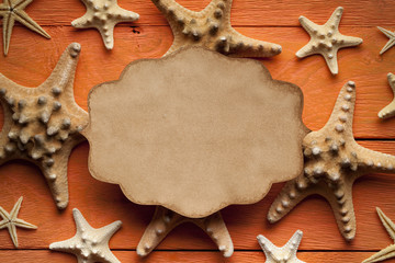 Fototapeta na wymiar Blank paper sheet and starfish on wooden background
