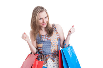 Portrait of cheerful smiling woman with shopping bags looking ex