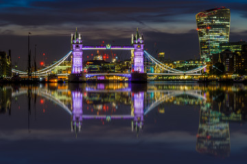 Illuminated London cityscape with Tower Bridge and 20 Fenchurch Street at sunset