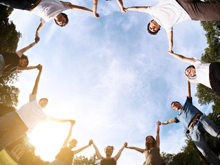 large group of friends together in a park having fun