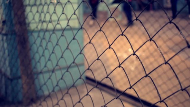 Wire fence. Closeup of steel net. Steel mesh. Security protection barrier in shopping center. Industrial security element. Fence made from steel wire. Net background. Metallic security net