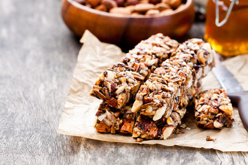 Healthy  protein granola bars with seeds and nuts on wooden back