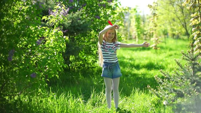 Adorable little girl dancing in the park