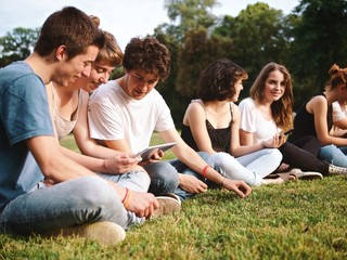 Naklejka premium large group of friends tohether in a park having fun