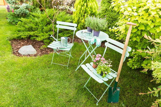 Spring garden - pastel green table with gardening tools