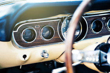Inside view of classic american muscle car, with focus on dashboard.