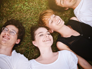 large group of friends tohether in a park having fun