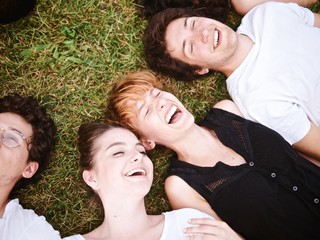 Fototapeta premium large group of friends tohether in a park having fun