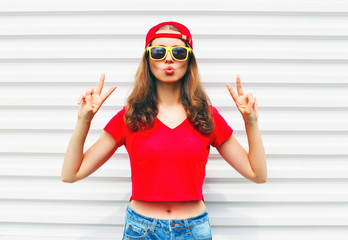 Fashion pretty cool woman in sunglasses and red t-shirt over whi