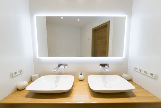 Two moderm sink in the bathroom, and big mirror