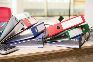 Stacks of office binders on desk