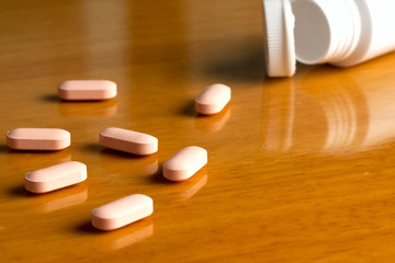 Many pills and tablets isolated on light background