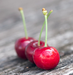 Fresh cherry berries on old wooden background.