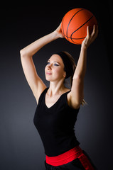 Woman with basketball in sport concept