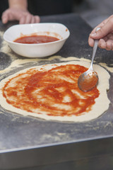 Woman chef with raw dough.