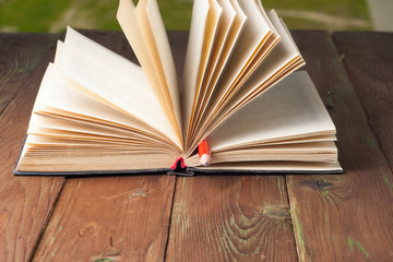 Close-up of open book and pen.