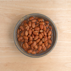 Bowl of shelled beans on a wood table top view.