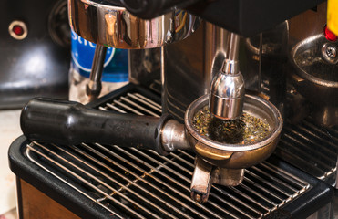 Close-up of espresso pouring from coffee machine. Professional coffee brewing
