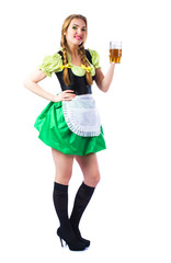 Beautiful sexy blond girl waitress Oktoberfest in Bavarian traditional dress with a glass of beer isolated on white background.
