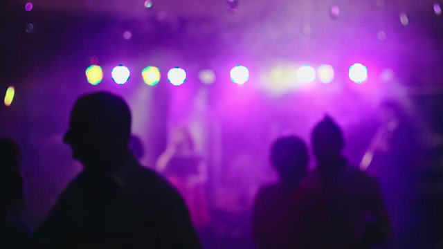 Pairs of men dancing a slow dance in a small club. RAW video record.