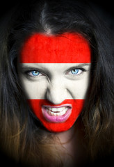 Portrait of a woman with the flag of the Austria painted on her face