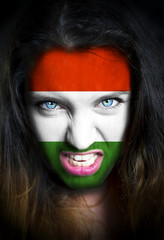 Portrait of a woman with the flag of the Hungary  painted on her face