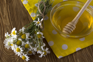 Fresh spring honey with chamomile flowers