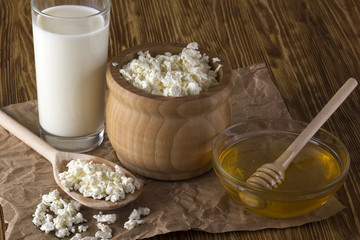 Honey, cottage cheese andglass with milk.