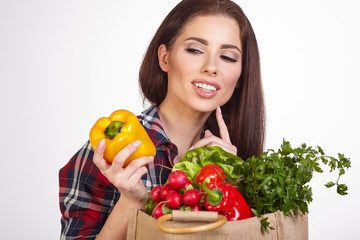 Isolated woman holding a shopping bag full of vegetables