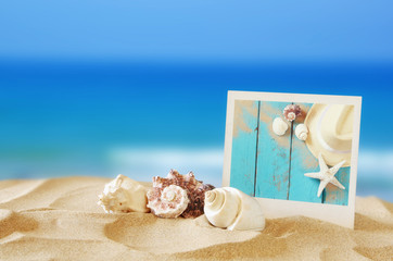 Beach with instant photo in front of sea background