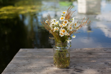 Bouquet of daisies in a jar