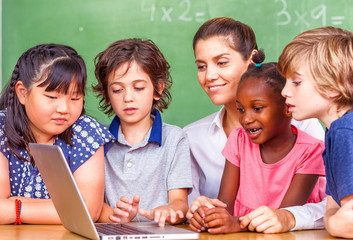 Beautiful teacher with mixed race classroom