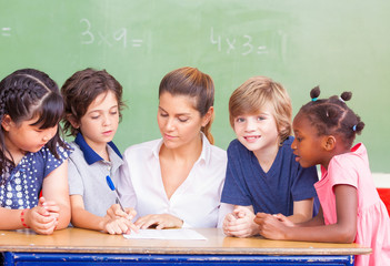 Happy children in a multi ethnic elementary classroom
