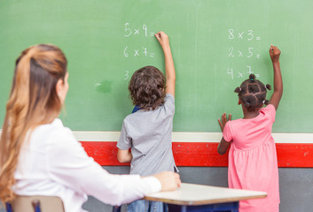 Beautiful teacher with mixed race classroom