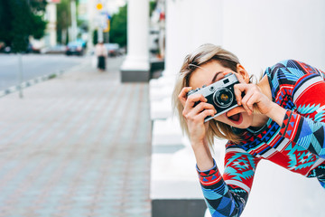 Woman photographed retro camera in the city