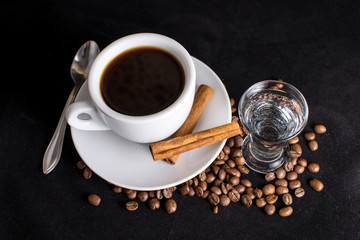 coffee, beans and cinnamon on dark background