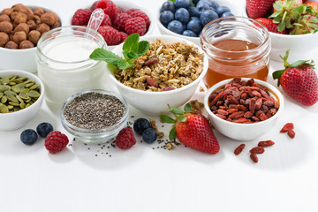 foods for healthy nutrition and fresh berries on white table