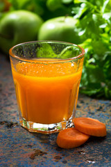 glass of fresh carrot juice, vertical, closeup