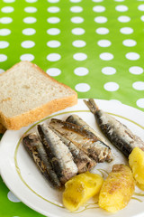 Marinated sardines served with potatoes and toast bread