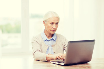 senior woman with laptop at home